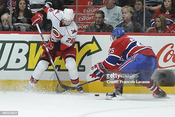 Erik Cole of the Carolina Hurricanes battles for the puck with Josh Gorges of Montreal Canadiens during the NHL game on March 31, 2010 at the Bell...