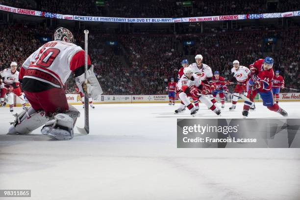 Tomas Plekanec of Montreal Canadiens takes a shot Cam Ward of the Carolina Hurricanes during the NHL game on March 31, 2010 at the Bell Center in...