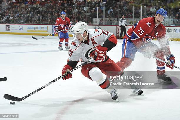Ray Whitney of the Carolina Hurricanes skates with the puck in front of Hal Gill of Montreal Canadiens during the NHL game on March 31, 2010 at the...