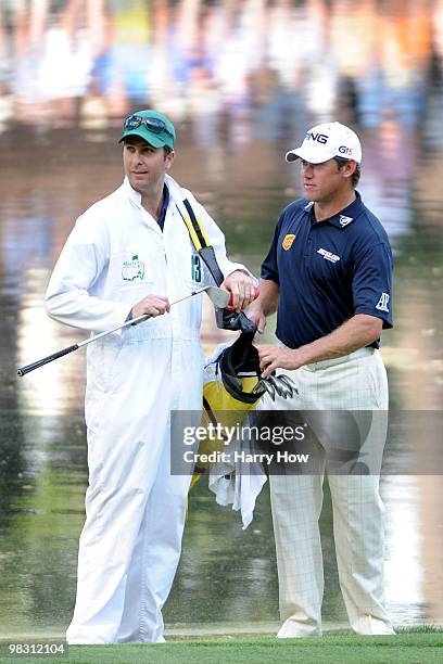 Lee Westwood of England waits with his caddie Michael Vaughn, former England cricket captain, during the Par 3 Contest prior to the 2010 Masters...