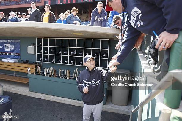 New York Yankees guest instructor Yogi Berra signing autographs for fans before spring training game vs Philadelphia Phillies at Bright House Field....