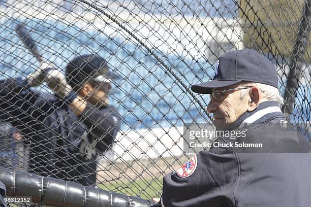 New York Yankees guest instructor Yogi Berra watches Jesus Montero take batting practice before spring training game vs Philadelphia Phillies at...