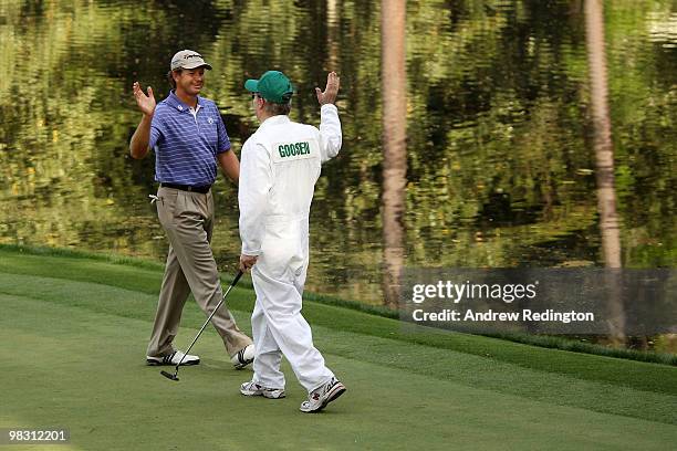 Retief Goosen of South Africa celebrates with his caddie during the Par 3 Contest prior to the 2010 Masters Tournament at Augusta National Golf Club...