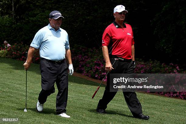 Ian Woosnam of Wales walks with Sandy Lyle of Scotland during the Par 3 Contest prior to the 2010 Masters Tournament at Augusta National Golf Club on...