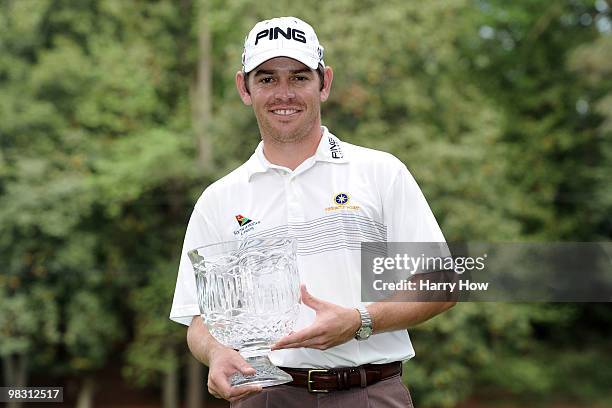 Louis Oosthuizen of South Africa poses with the trophy after winning the Par 3 Contest prior to the 2010 Masters Tournament at Augusta National Golf...
