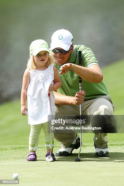 Henrik Stenson of Sweden waits with his daughter Lisa during the Par 3 Contest prior to the 2010 Masters Tournament at Augusta National Golf Club on...