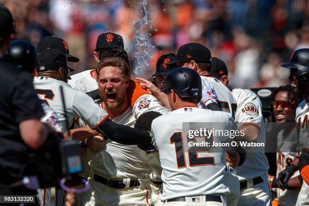 Hunter Pence of the San Francisco Giants is congratulated by teammates after hitting a two run walk off double against the San Diego Padres during...