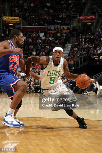 Rajon Rondo of the Boston Celtics drives to the basket against Leon Powe of the Cleveland Cavaliers during the game at Quicken Loans Arena on March...