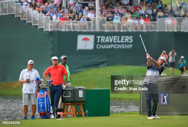 Bubba Watson plays a tee shot on the 16th hole during the final round of the Travelers Championship at TPC River Highlands on June 24, 2018 in...
