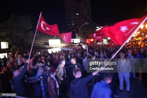 Supporters of Turkish President and the leader of the Justice and Development Party Recep Tayyip Erdogan celebrate as unofficial results show Erdogan...