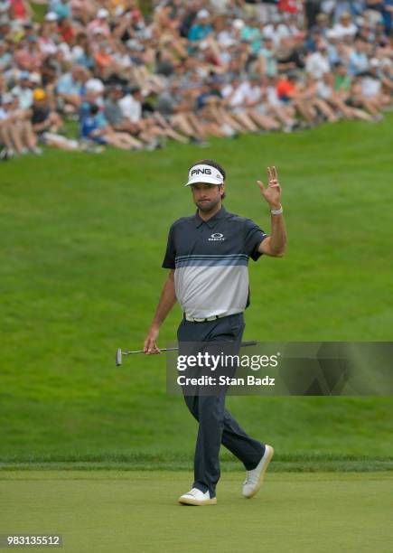 Bubba Watson acknowledges the gallery walking along the 18th hole during the final round of the Travelers Championship at TPC River Highlands on June...