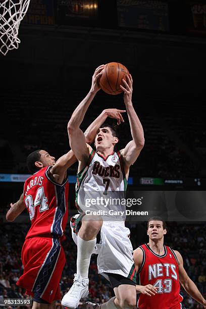 Devin Harris of the New Jersey Nets fouls Ersan Ilyasova of the Milwaukee Bucks on April 7, 2010 at the Bradley Center in Milwaukee, Wisconsin. NOTE...