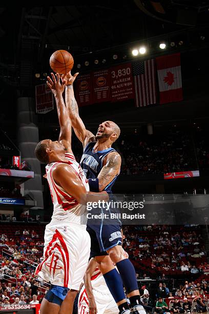 Carlos Boozer of the Utah Jazz shoots the ball over Chuck Hayes of the Houston Rockets on April 7, 2010 at the Toyota Center in Houston, Texas. NOTE...