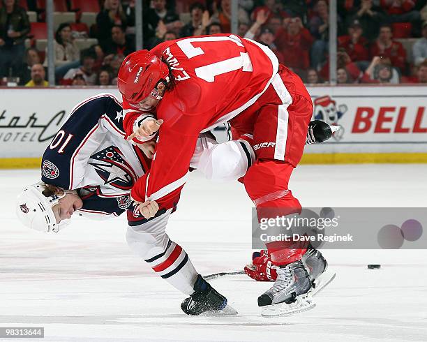 Patrick Eaves of the Detroit Red Wings gets tangled up with Kris Russell of the Columbus Blue Jackets during an NHL game at Joe Louis Arena on April...