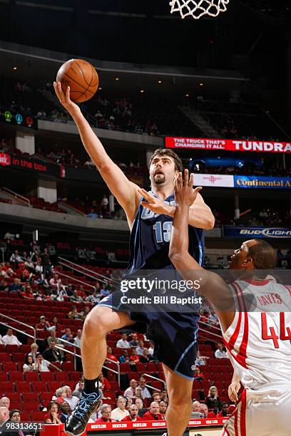 Mehmet Okur of the Utah Jazz shoots the ball over Chuck Hayes of the Houston Rockets on April 7, 2010 at the Toyota Center in Houston, Texas. NOTE TO...