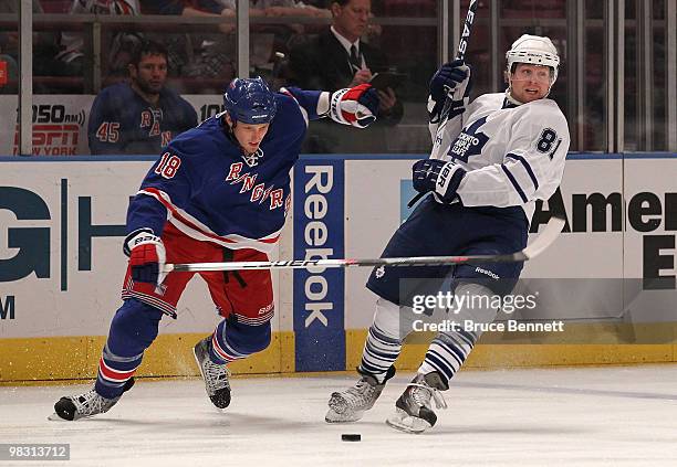 Phil Kessel of the Toronto Maple Leafs is knocked off balance by Marc Staal of the New York Rangers at Madison Square Garden on April 7, 2010 in New...