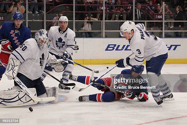 Jonas Gustavsson and Dion Phaneuf of the Toronto Maple Leafs combine to stop Chris Drury of the New York Rangers at Madison Square Garden on April 7,...