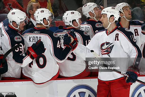Umberger of the Columbus Blue Jackets gets congratulated by teammates for his goal on the Detroit Red Wings during an NHL game at Joe Louis Arena on...