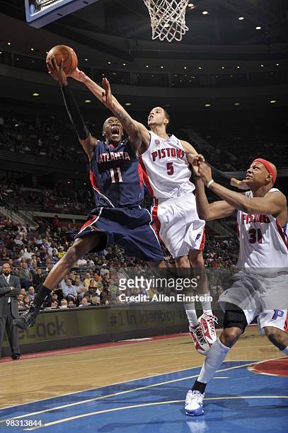 Jamal Crawford of the Atlanta Hawks goes up for a shot attempt against Austin Daye of the Detroit Pistons in a game at the Palace of Auburn Hills on...