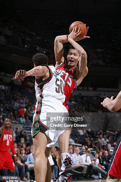 Yi Jianlian of the New Jersey Nets grabs a rebound against Dan Gadzuric of the Milwaukee Bucks on April 7, 2010 at the Bradley Center in Milwaukee,...