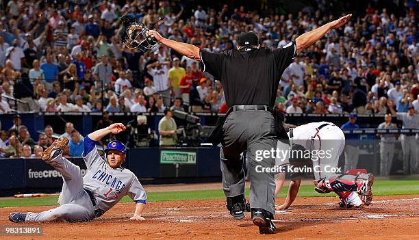 Mike Fontenot of the Chicago Cubs slides in safely at home plate against the Atlanta Braves at Turner Field on April 7, 2010 in Atlanta, Georgia.