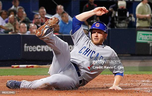 Mike Fontenot of the Chicago Cubs slides in safely at home plate against the Atlanta Braves at Turner Field on April 7, 2010 in Atlanta, Georgia.