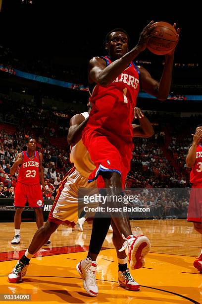 Samuel Dalembert of the Philadelphia 76ers grabs a rebound against the Miami Heat on April 7, 2010 at American Airlines Arena in Miami, Florida. NOTE...