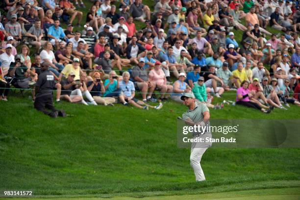 Jason Day of Australia plays a chip shot on the 18th hole during the final round of the Travelers Championship at TPC River Highlands on June 24,...