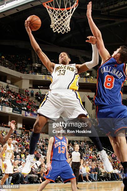 Danny Granger of the Indiana Pacers lays the ball up and over Danilo Gallinari of the New York Knicks at Conseco Fieldhouse on April 7, 2010 in...