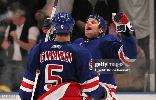 Dan Girardi of the New York Rangers greets teammate Olli Jokinen following his third-period goal against the Toronto Maple Leafs at Madison Square...
