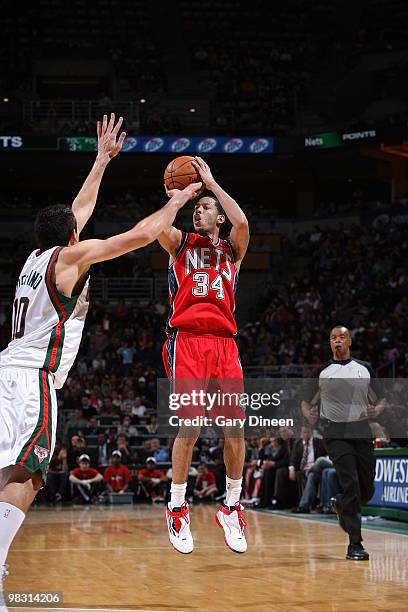 Devin Harris of the New Jersey Nets shoots a jumpshot against Carlos Delfino of the Milwaukee Bucks on April 7, 2010 at the Bradley Center in...