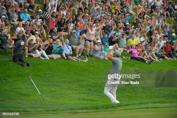 Fans celebrate with Jason Day of Australia after his chip in for birdie on the 18th hole during the final round of the Travelers Championship at TPC...