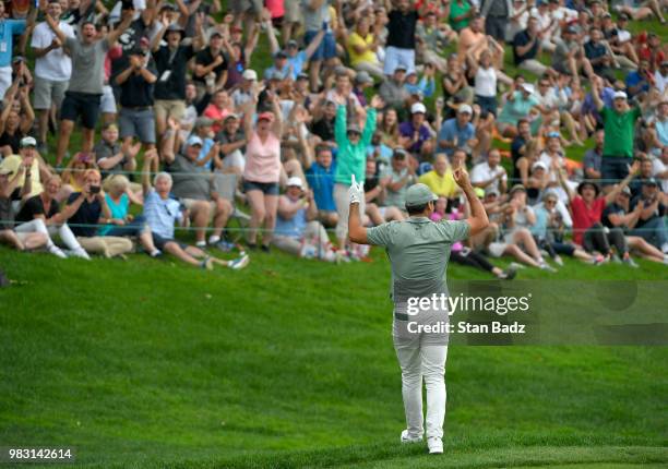 Fans celebrate with Jason Day of Australia after his chip in for birdie on the 18th hole during the final round of the Travelers Championship at TPC...