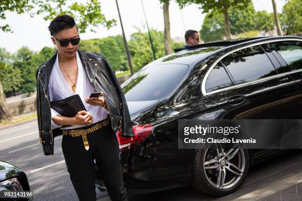 Guest, wearing white shirt, black leather jacket and Balmain hand bag, is seen in the streets of Paris before the Balmain show, during Paris Men's...