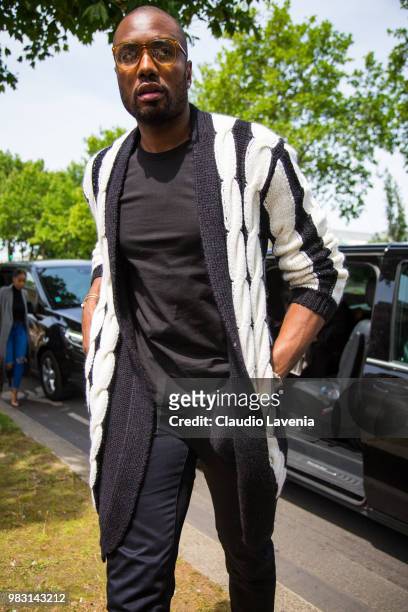 Serge Ibaka, wearing black t shirt, black pants and black and white coat, is seen in the streets of Paris before the Balmain show, during Paris Men's...