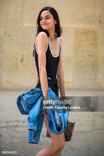 Model, wearing Adidas black and white top, denim shorts and Fendi bag, is seen in the streets of Paris after the Balmain show, during Paris Men's...