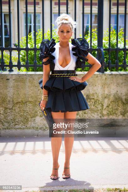Ashley Hutson, wearing black and white dress and black bag, is seen in the streets of Paris after the Balmain show, during Paris Men's Fashion Week...