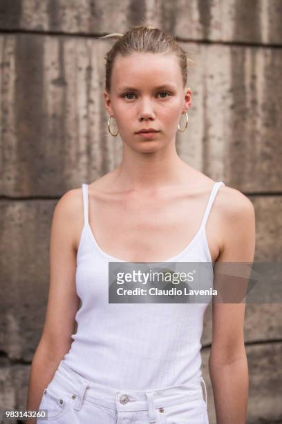 Model, wearing white top, is seen in the streets of Paris after the Y-3 show, during Paris Men's Fashion Week Spring/Summer 2019 on June 24, 2018 in...