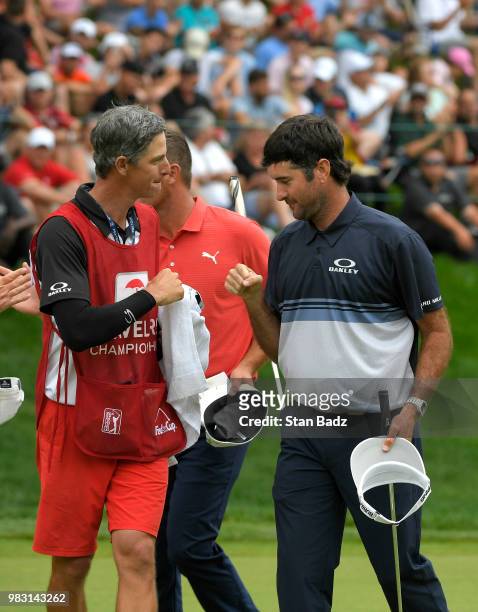 Caddie Ted Scott and Bubba Watson celebrate their win on the 18th hole during the final round of the Travelers Championship at TPC River Highlands on...
