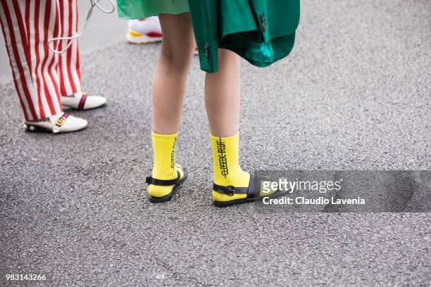 Fashion details of yellow socks and black sandals, are seen in the streets of Paris after the Y-3 show, during Paris Men's Fashion Week Spring/Summer...
