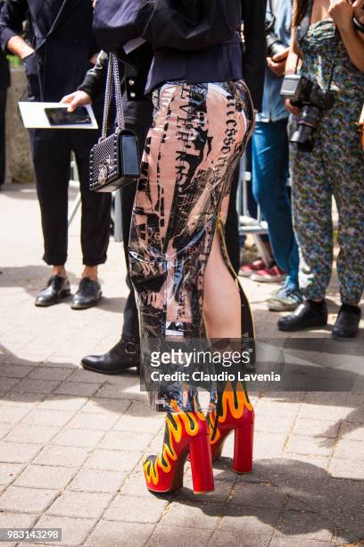 Fashion details of latex skirt, heels boots whit flames and Balmain bag, are seen in the streets of Paris before the Balmain show, during Paris Men's...