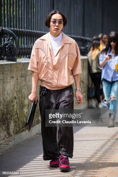 Guest, wearing pink shirt and black pants, is seen in the streets of Paris before the Balmain show, during Paris Men's Fashion Week Spring/Summer...
