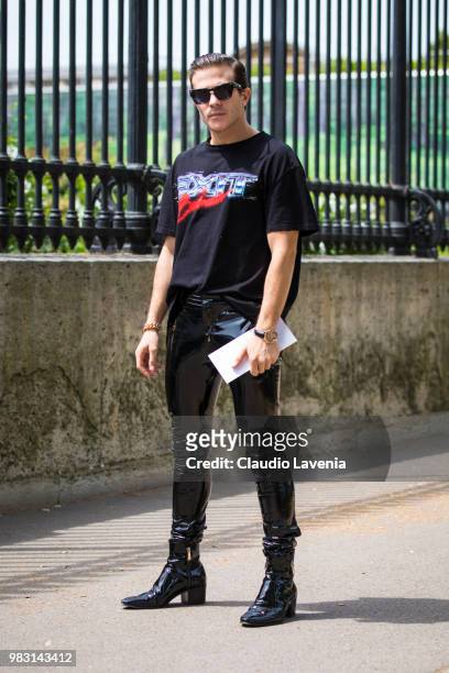 Carlo Sestini, wearing Balmain t shirt and latex black pants, is seen in the streets of Paris before the Balmain show, during Paris Men's Fashion...