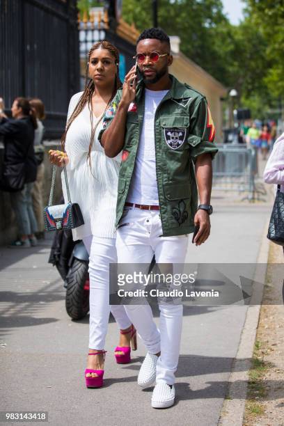 Guest, wearing green jacket, white t shirt and white pants, is seen in the streets of Paris before the Balmain show, during Paris Men's Fashion Week...