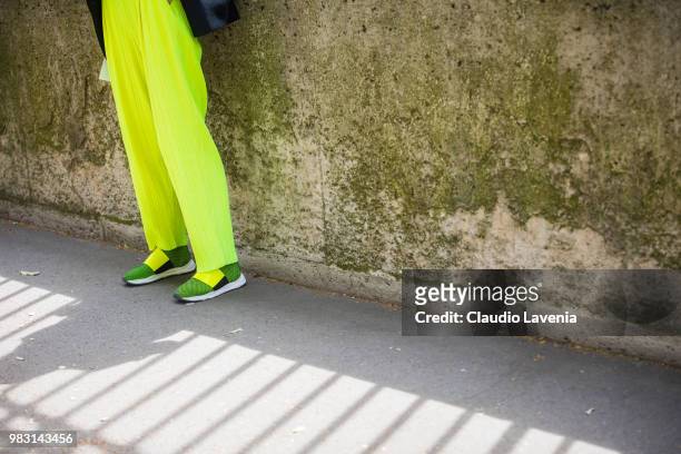 Fashion detail of Caro Daur fluo pants, is seen in the streets of Paris before the Balmain show, during Paris Men's Fashion Week Spring/Summer 2019...