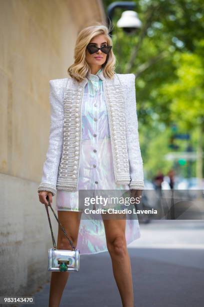 Xenia Adonts Overdose, wearing white jacket, white latex dress and Balmain bag, is seen in the streets of Paris before the Balmain show, during Paris...