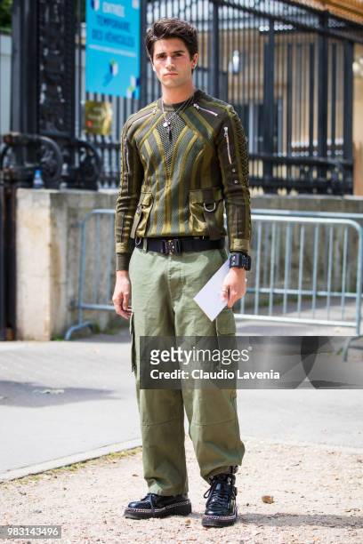 Marc Forne, wearing green sweater and green pants, is seen in the streets of Paris before the Balmain show, during Paris Men's Fashion Week...
