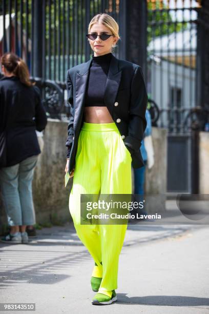 Caro Daur, wearing black top, Balmin black jacket and fluo pants, is seen in the streets of Paris before the Balmain show, during Paris Men's Fashion...