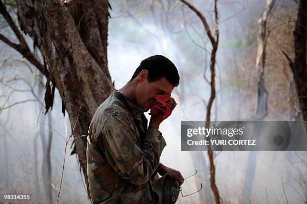 David Chavez, a member of the Mounted Police wipes his face during a brreak after fighting the a forest fire at the National Palo Verde Park on April...