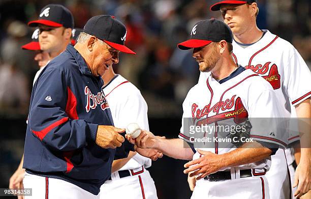 Reliever Billy Wagner of the Atlanta Braves hands the game ball over to manager Bobby Cox after their 3-2 win over the Chicago Cubs at Turner Field...